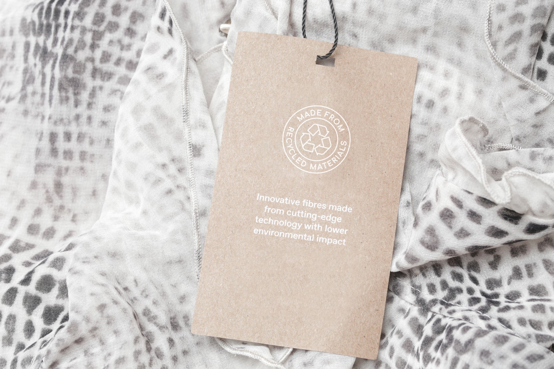 Close up of clothing tag with recycle icon. Recycling products concept. Zero waste, suistainale production, environment care and reuse concept.